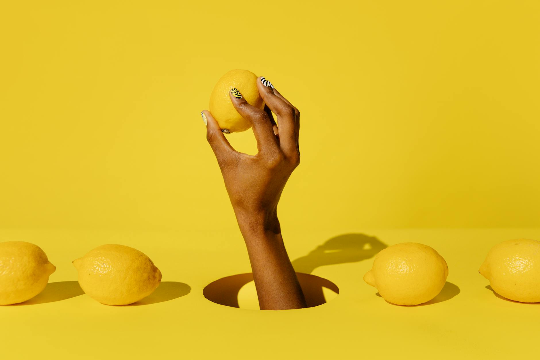 Vibrant collection of colorful lemon vibrators and clitoral toys arranged on a bright yellow surface