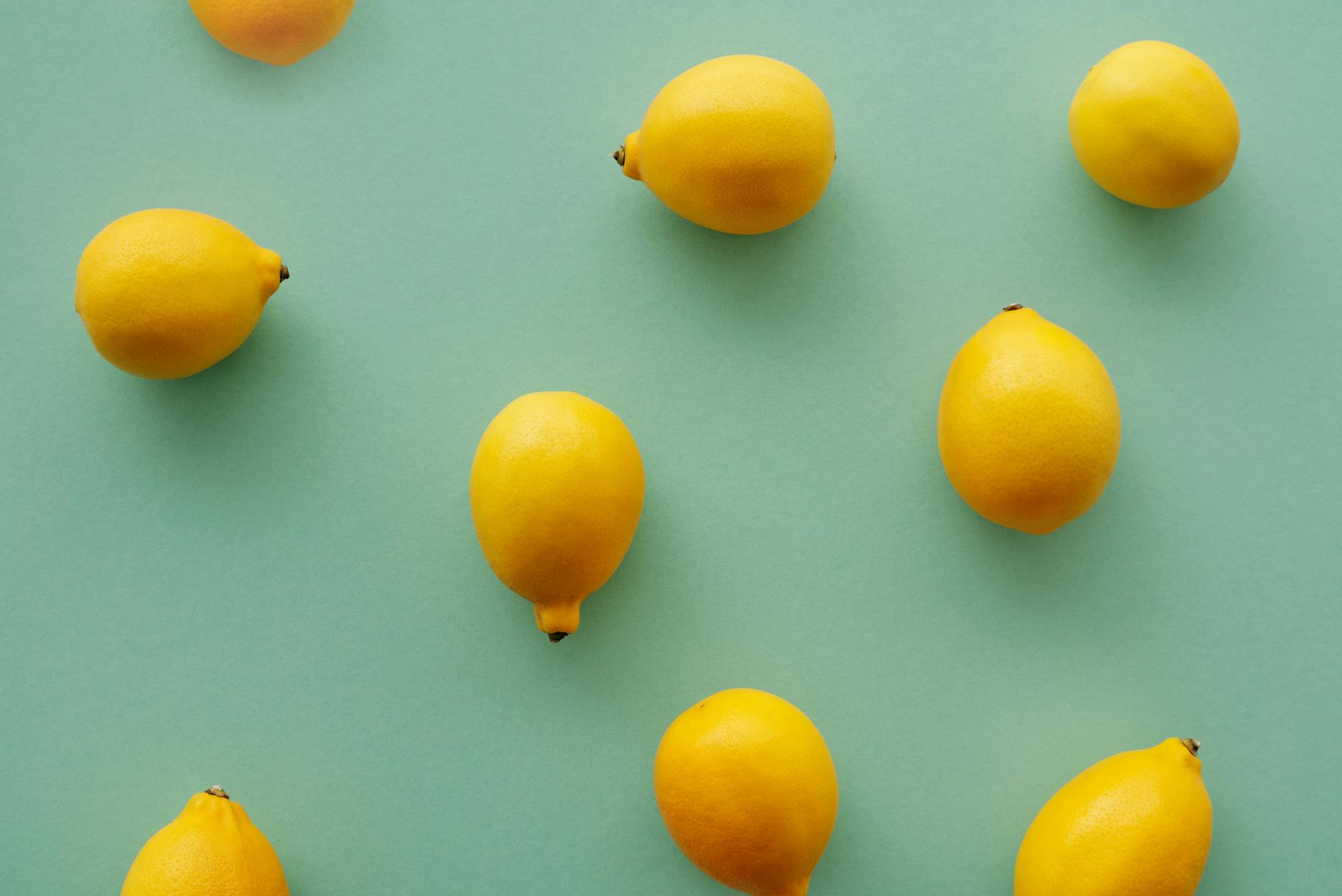 Woman holding colorful lemon vibrators in contemplative moment