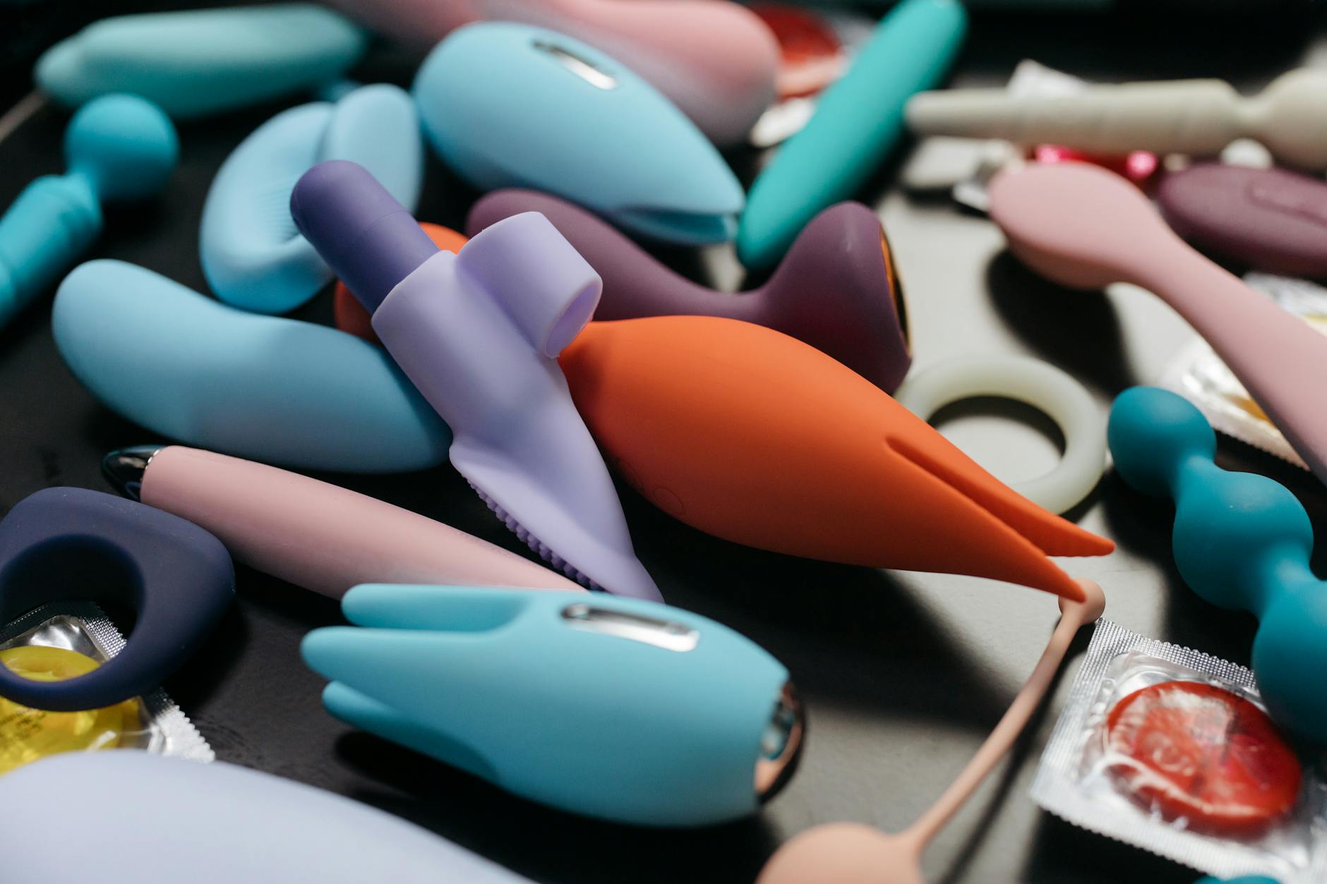 Woman holding silicone vibrators thoughtfully while considering pleasure restoration options