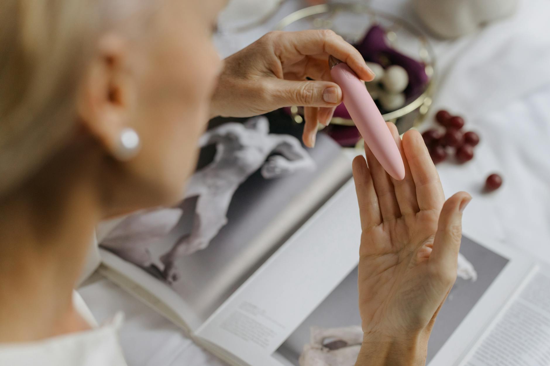 Close-up of hands holding a vibrator, emphasizing intimate reconnection with pleasure during medication adjustments