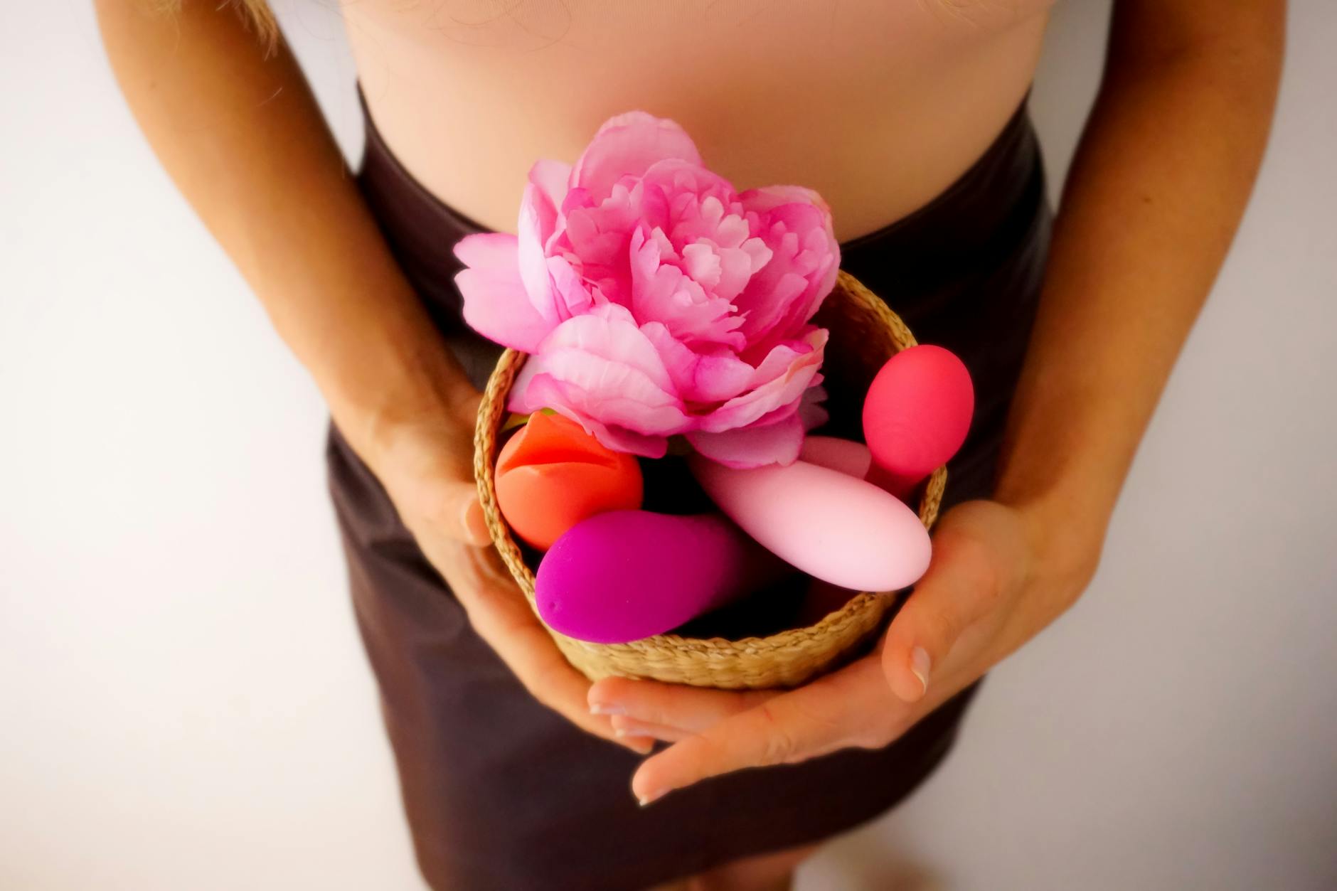 Woman holding clitoral vibrators, representing mature sensuality and self-care