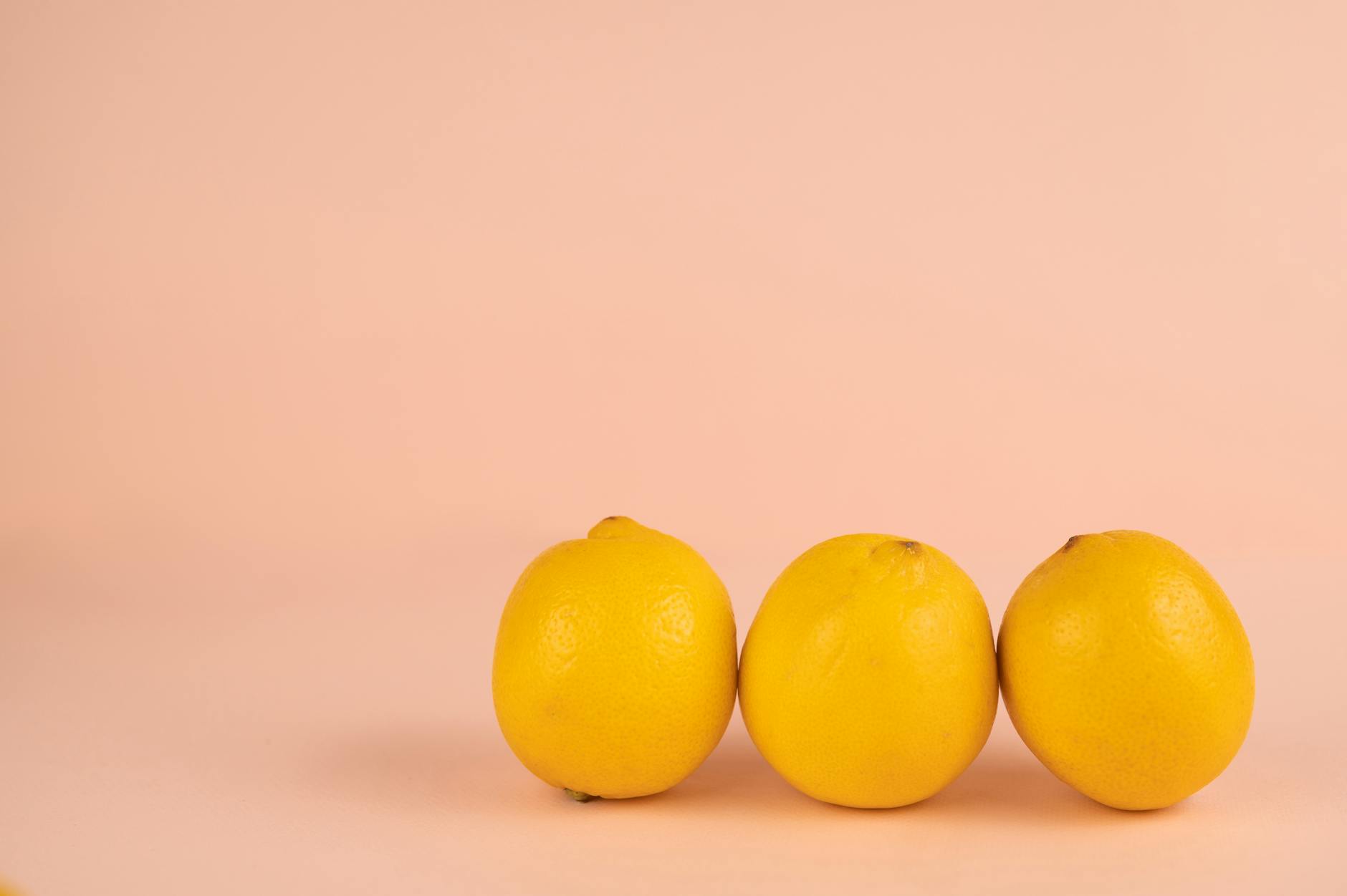 Bright ripe lemons arranged on a pastel background, symbolizing renewed sensation and freshness