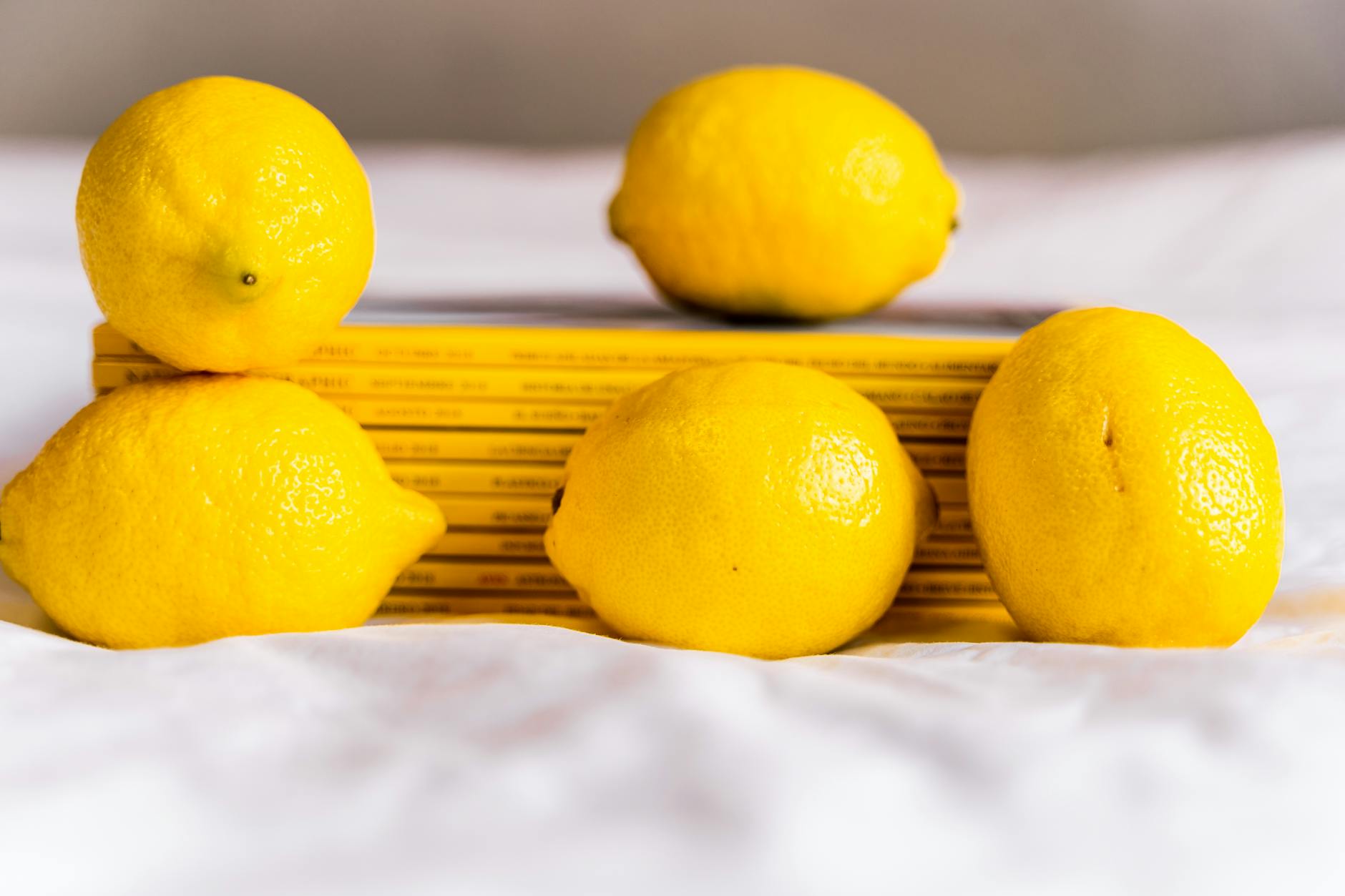 Fresh lemons arranged with books on white surface, representing renewal during life transitions